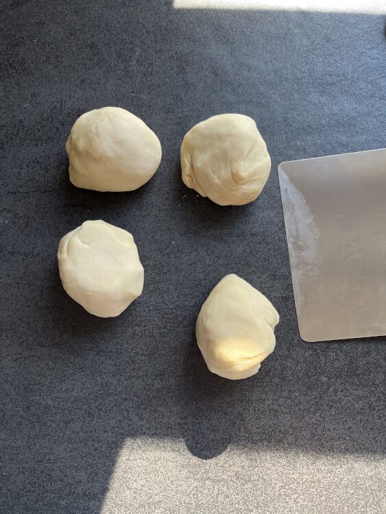 Nach der Ruhezeit den Teig in 4 gleichgroße Portionen teilen